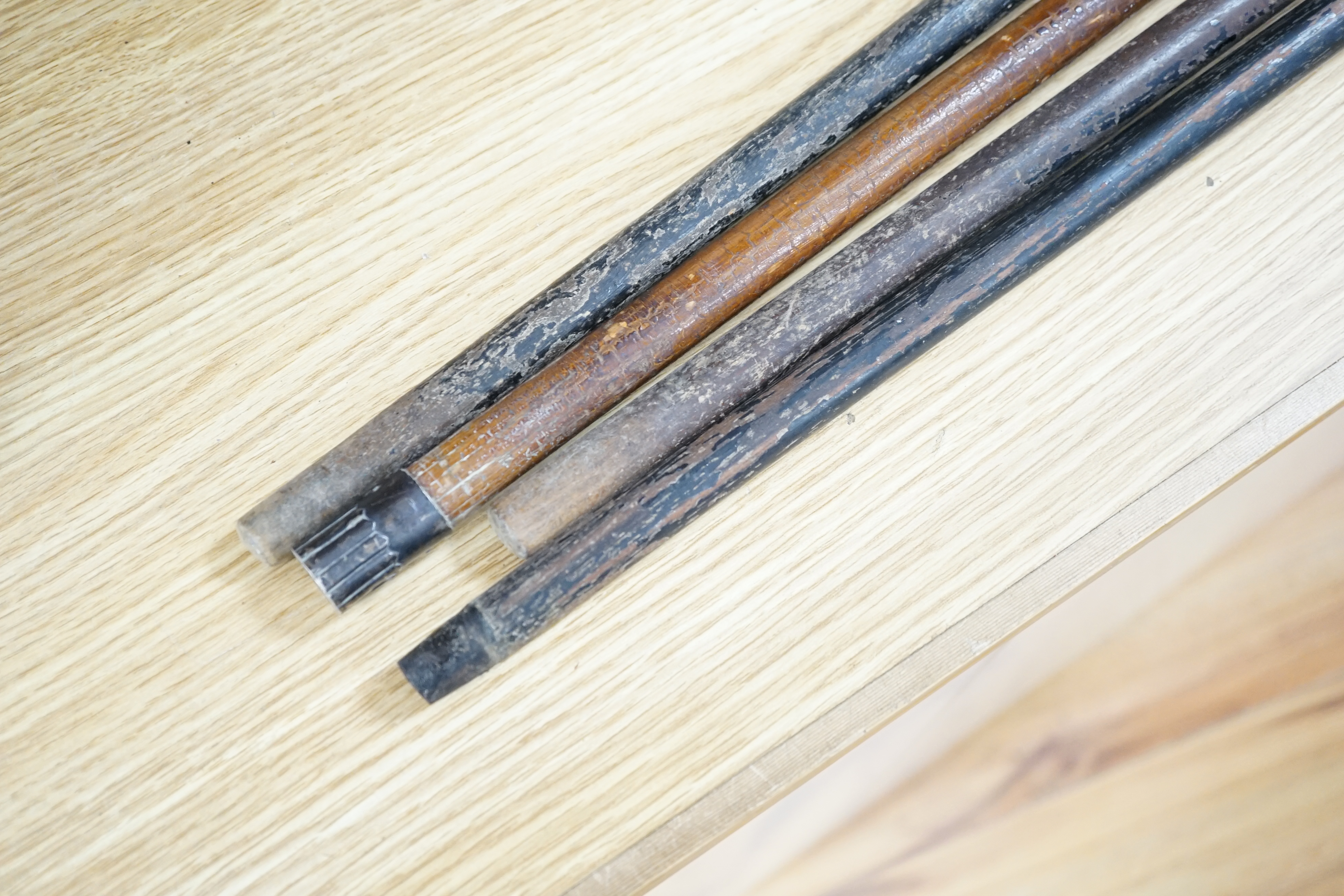 Four Victorian silver mounted handled walking sticks: one being a sword stick, sword stick 90cm long